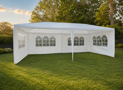 3x6m white marquee with side walls and arched windows set up on grass in a Brisbane backyard