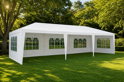 3x9m white marquee with removable side walls and arched windows set up on a lawn